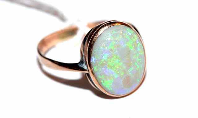 Appraisal: A SINGLE STONE OPAL RING oval opal mounted in a