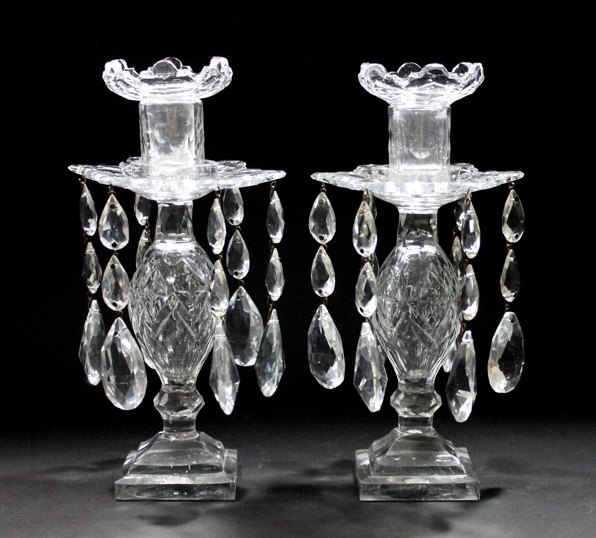 Appraisal: A pair of Victorian cut glass lustre candlesticks each with