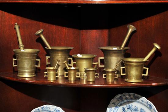 Appraisal: NINE BRASS MORTARS AND PESTLES Graduated assembled set of cast