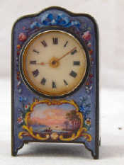 Appraisal: A miniature clock the silver case enamelled on face and