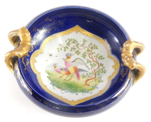 Appraisal: A Continental porcelain bowl on blue ground decorated with a