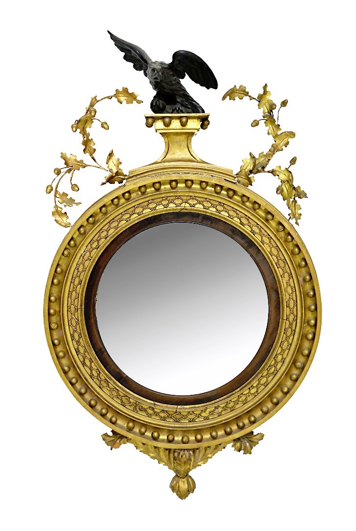 Appraisal: A Regency gilt framed convex wall mirror with ebonised eagle