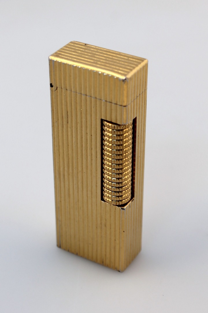 Appraisal: A thC Dunhill cigarette lighter the ribbed gilt metal casing