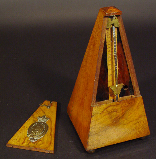 Appraisal: French walnut cased pyramid metronome with applied brass manufacturer's plaque