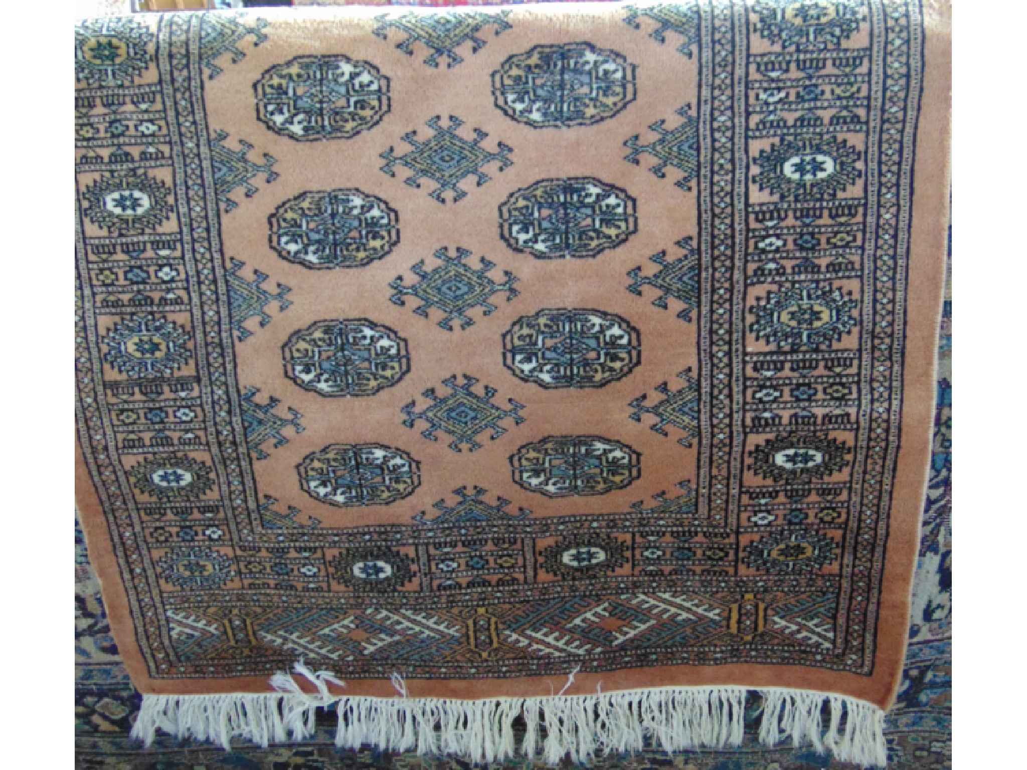 Appraisal: An Afghan style wool work rug with a pale pink