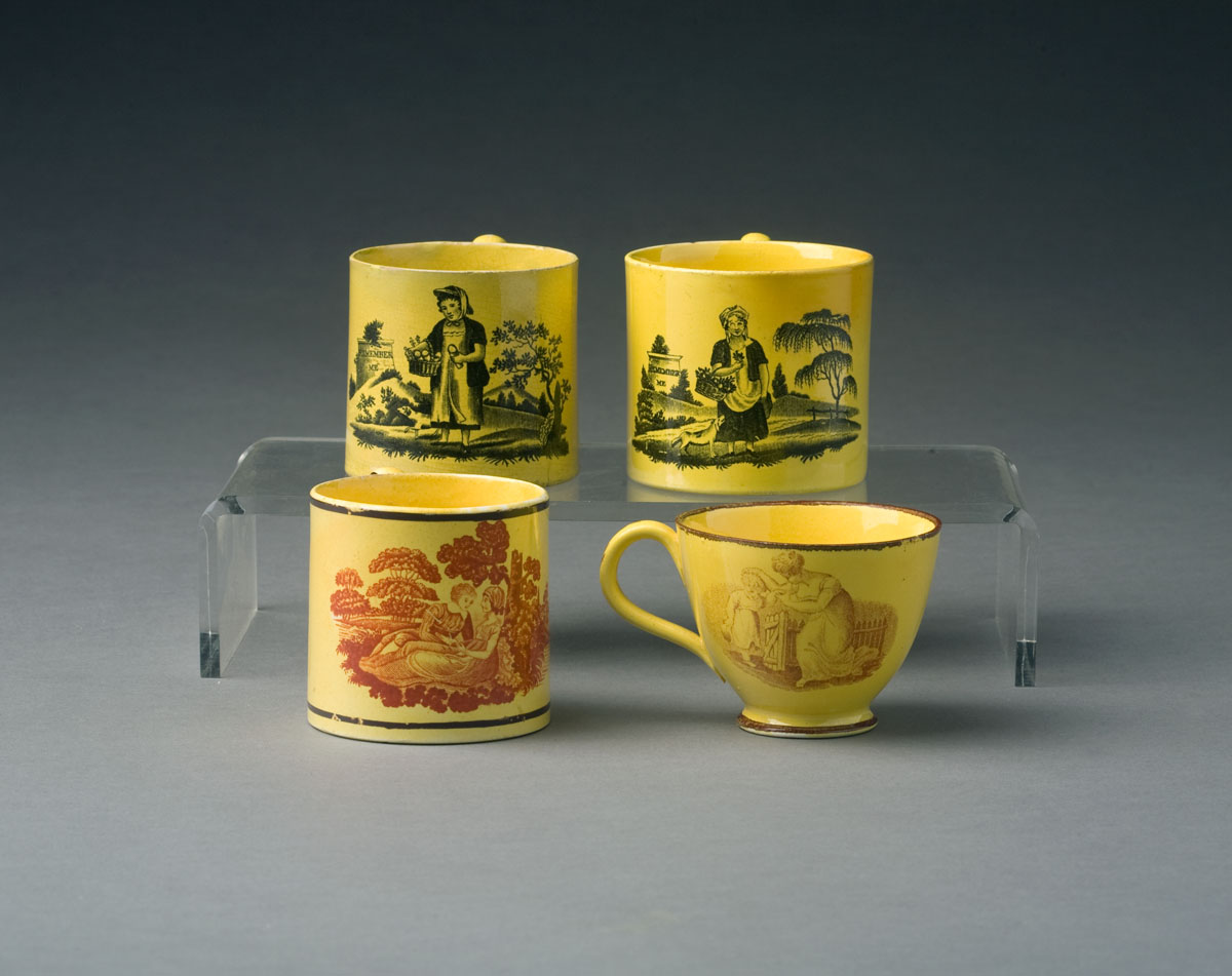 Appraisal: THREE ENGLISH YELLOW-GLAZED TRANSFER-PRINTED CHILDREN'S MUGS AND A TEACUP CIRCA