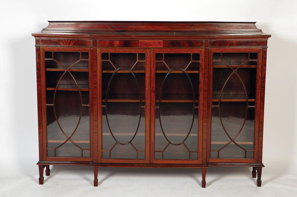 Appraisal: A GEORGE III STYLE MAHOGANY AND SATINWOOD STRUNG BREAKFRONT BOOKCASE