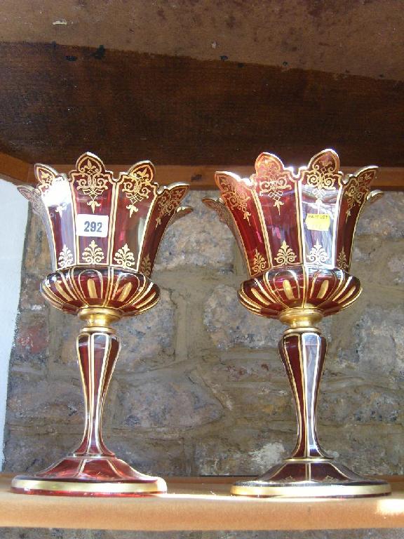 Appraisal: A pair of th century cranberry glass stemmed vases with