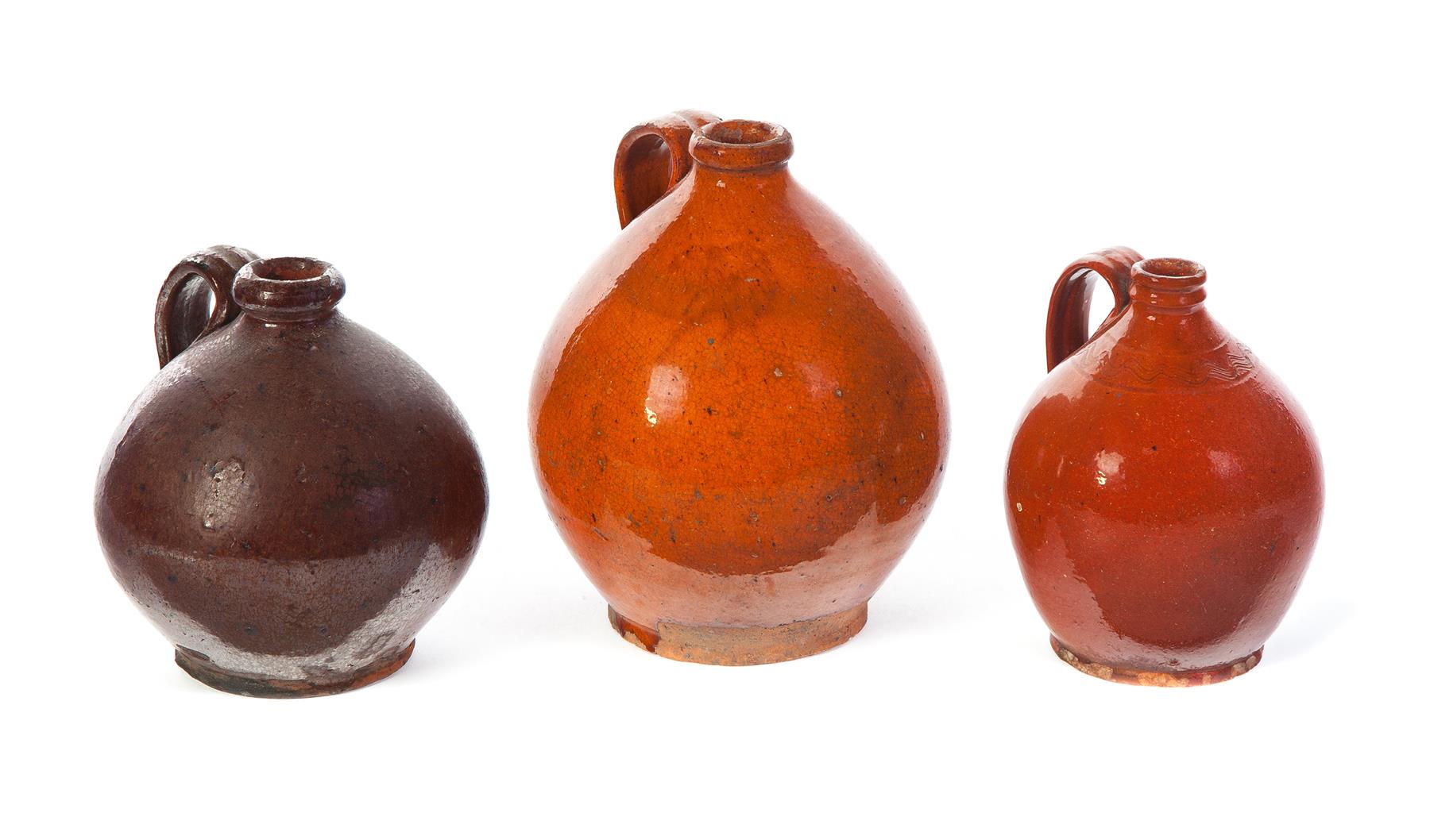 Appraisal: THREE AMERICAN OVOID JUGS Mid th century Ovoid with applied