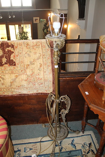 Appraisal: AN EDWARDIAN GILT METAL STANDARD LAMP with adjustable column and