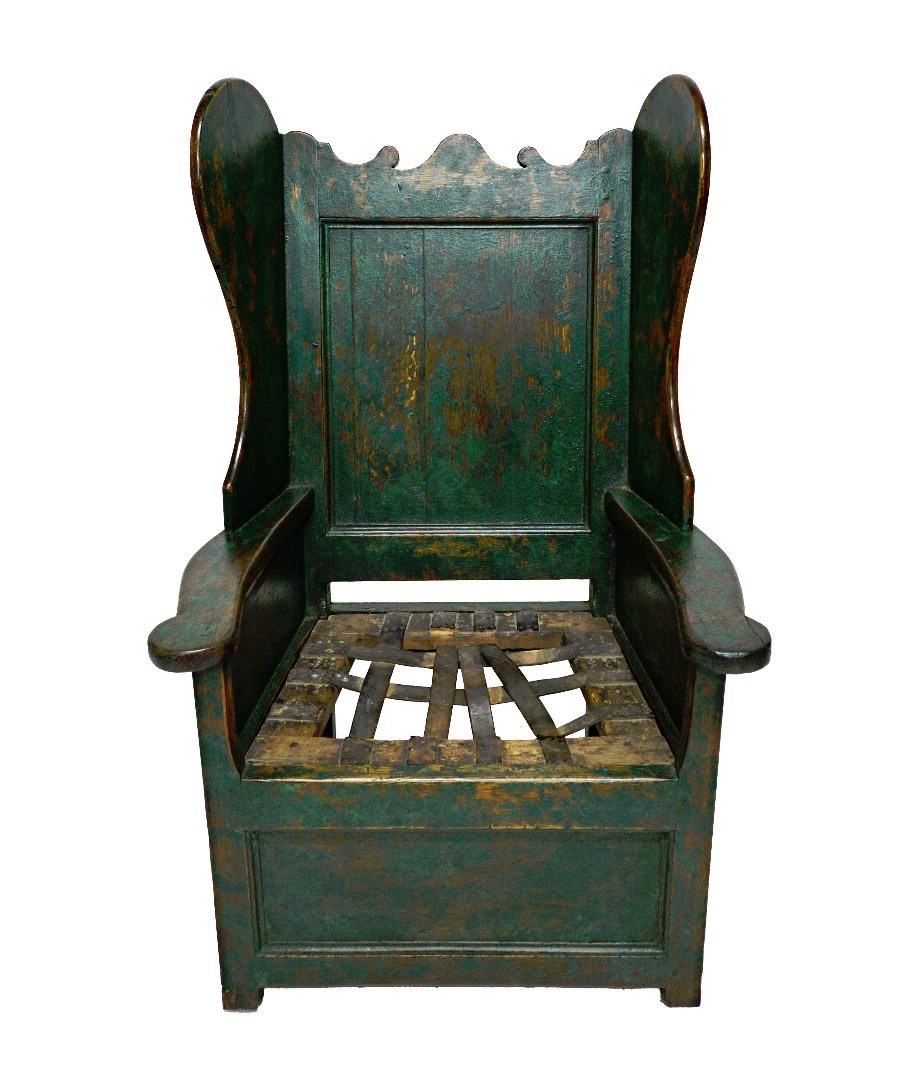 Appraisal: An th century green painted oak panelled wingback lambing chair