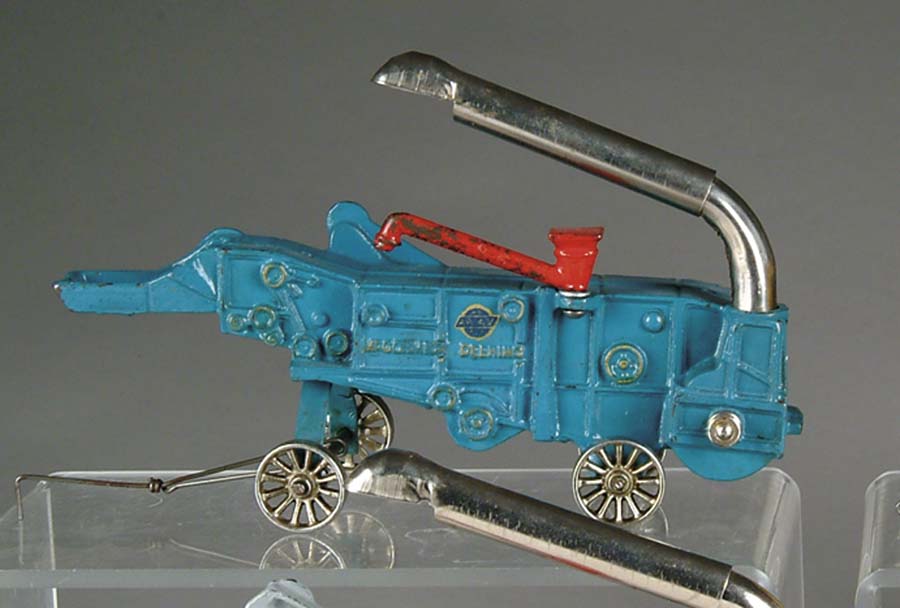 Appraisal: MCCORMICK-DEERING COMBINE BY ARCADE Painted in blue and embossed MCCORMICK-DEERING