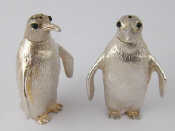 Appraisal: A silver pepper and salt modelled as penguins with inset