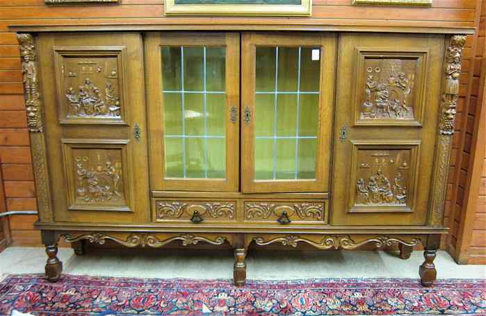 Appraisal: LARGE FOUR-DOOR CARVED OAK CABINET BOOKCASE German th century centering