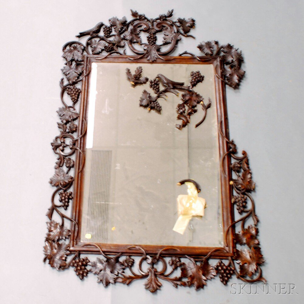 Appraisal: Rococo-style Carved Walnut Mirror the frame with carved applied grapes