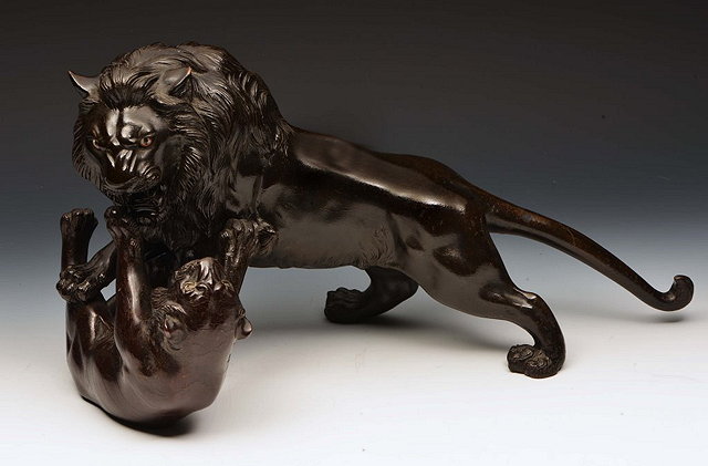 Appraisal: A JAPANESE BRONZE GROUP OF FIGHTING TIGER and tigress signed