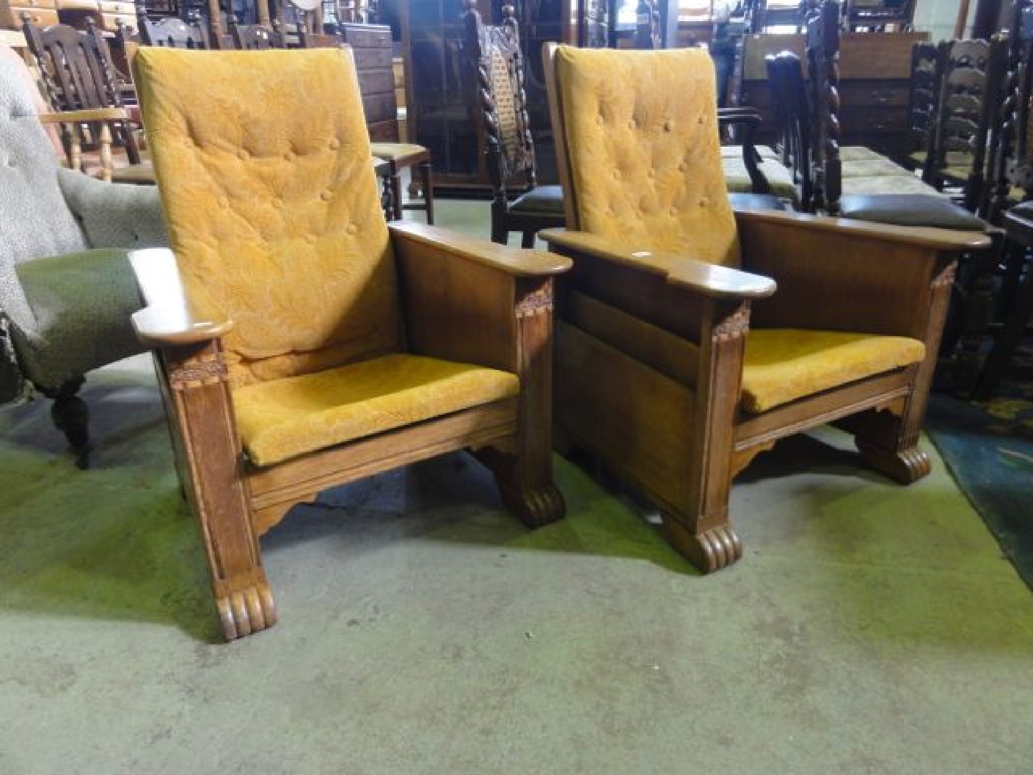 Appraisal: A pair of early th century oak framed reclining chairs