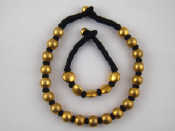 Appraisal: A gilt metal tests silver and cotton bead necklace with