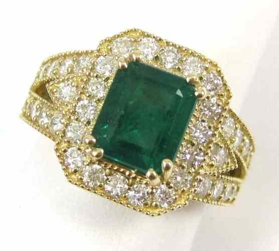 Appraisal: EMERALD DIAMOND AND FOURTEEN KARAT GOLD RING round-cut diamonds surround