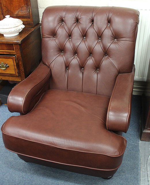 Appraisal: A PAIR OF THOMAS LLOYD BROWN LEATHER BUTTONBACK UPHOLSTERED ARMCHAIRS