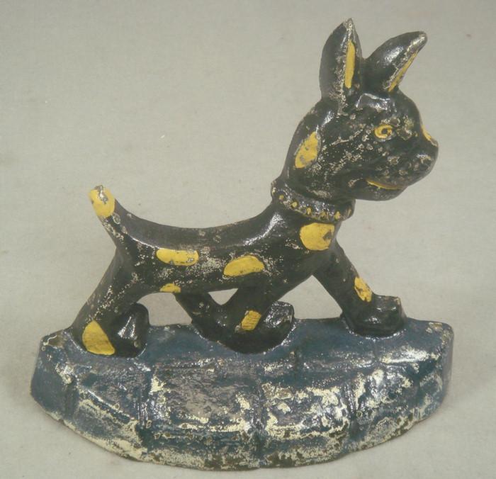 Appraisal: Cast iron doorstop black and yellow spotted caricature dog on