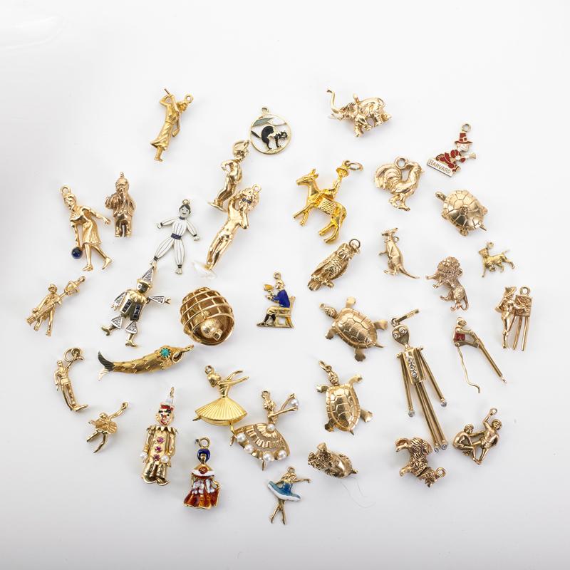 Appraisal: THIRTY-SIX CHARACTER OR ANIMAL YELLOW GOLD CHARMS Condition Report