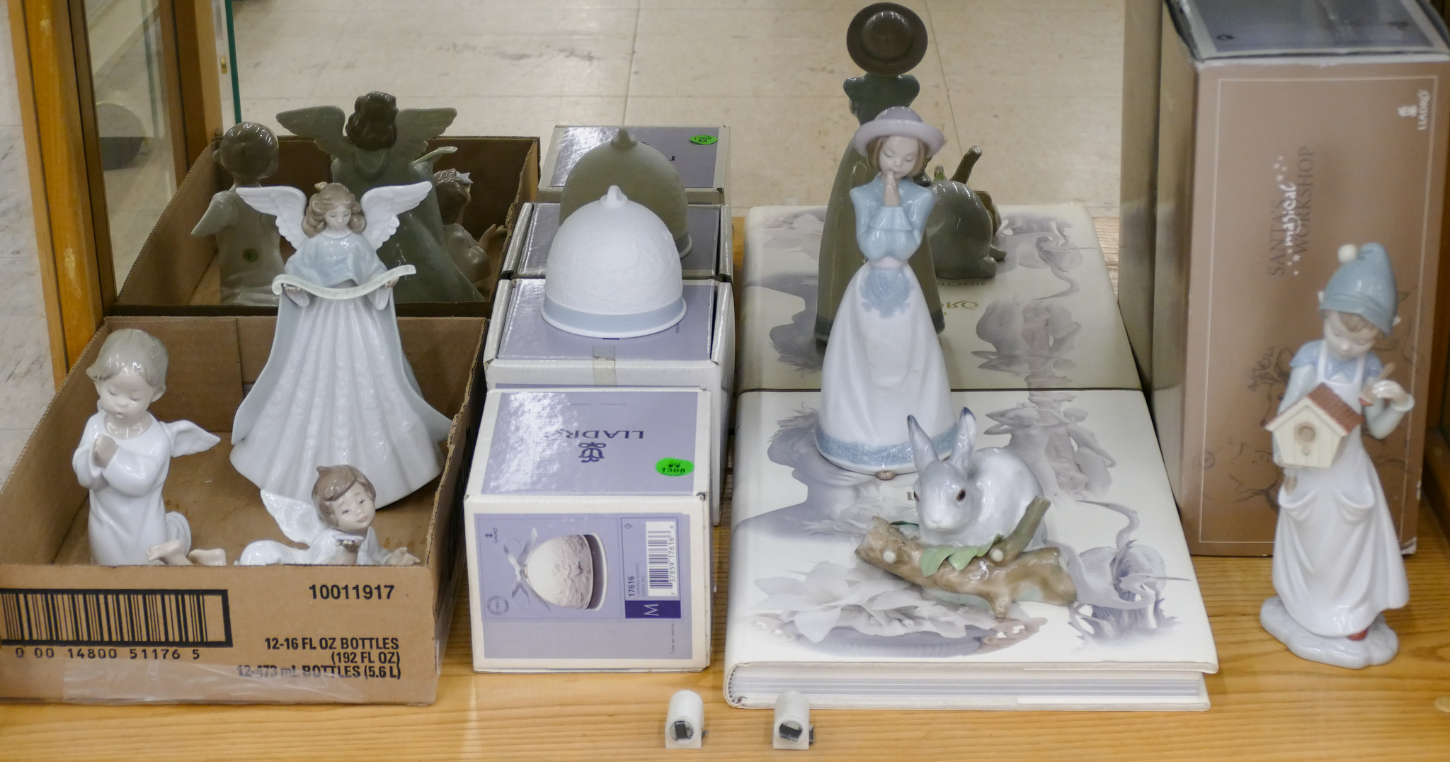 Appraisal: Shelf pc Lladro Porcelain Figurines and Books - Some Boxes