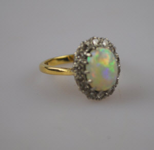 Appraisal: Opal and diamond cluster ring yellow and metal set stamped