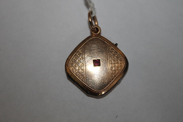 Appraisal: A VICTORIAN OR EDWARDIAN GOLD LOCKET inset central garnet or