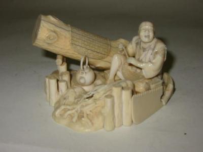 Appraisal: A JAPANESE CARVED IVORY OKIMONO Meiji period depicting a seated