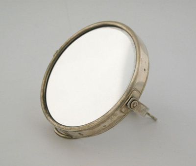 Appraisal: A modern mounted shaving mirror with an adjustable wire stand