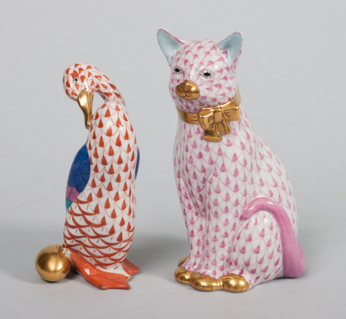 Appraisal: Two Herend porcelain animals seated cat in the Raspberry Fishnet