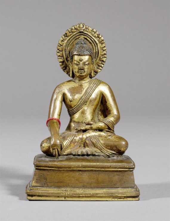 Appraisal: A GILT COPPER FIGURE OF BUDDHA SHAKYAMUNI ON A RECTANGULAR