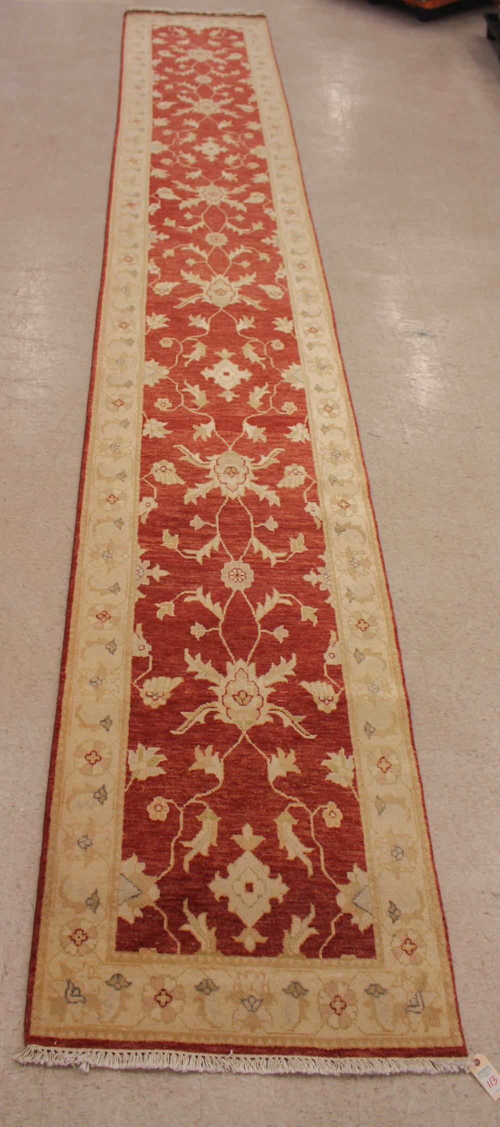 Appraisal: HAND KNOTTED ORIENTAL LONG RUG Pakistani-Persian overall scrolling floral design