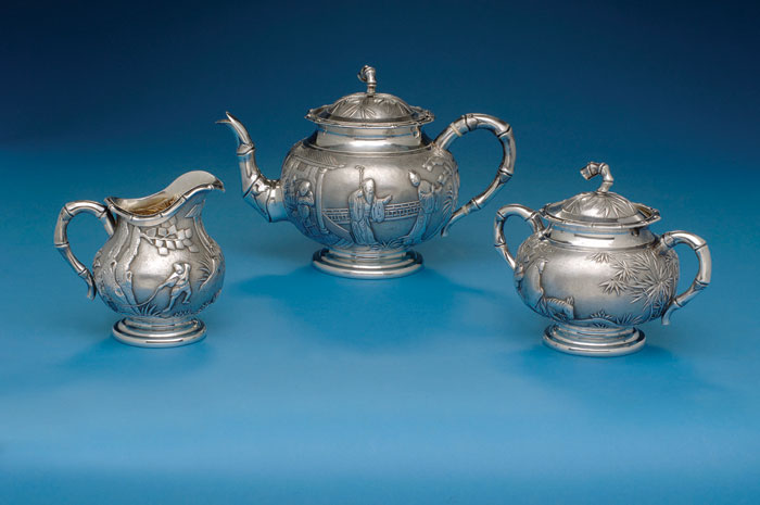 Appraisal: CHINA TRADE SILVER THREE-PART REPOUSSED TEA SERVICE Consisting of a