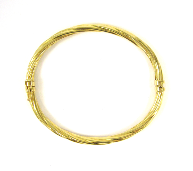 Appraisal: FOURTEEN KARAT YELLOW GOLD CABLE BANGLE The oval hinged bangle