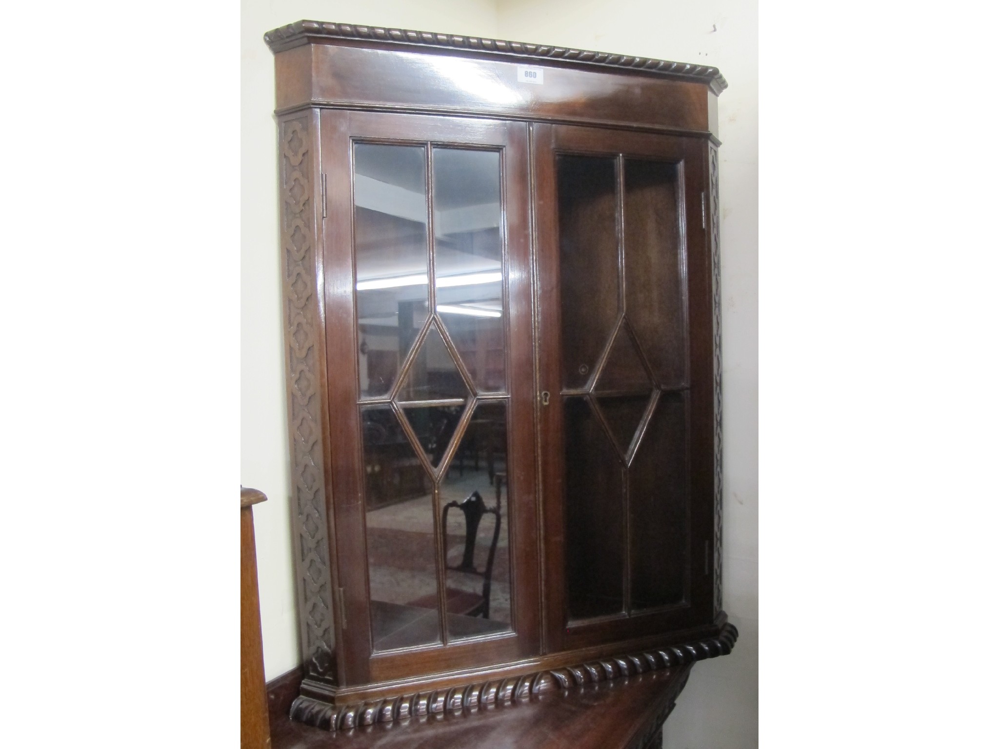 Appraisal: Carved mahogany glazed wall hanging corner cabinet