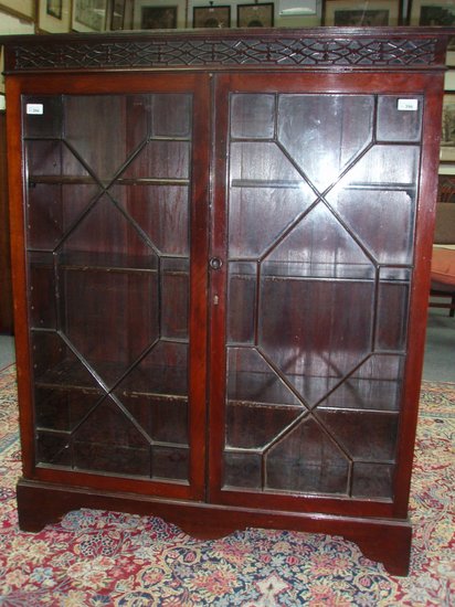 Appraisal: A mahogany bookcase with astragal glazed panel door cm wide