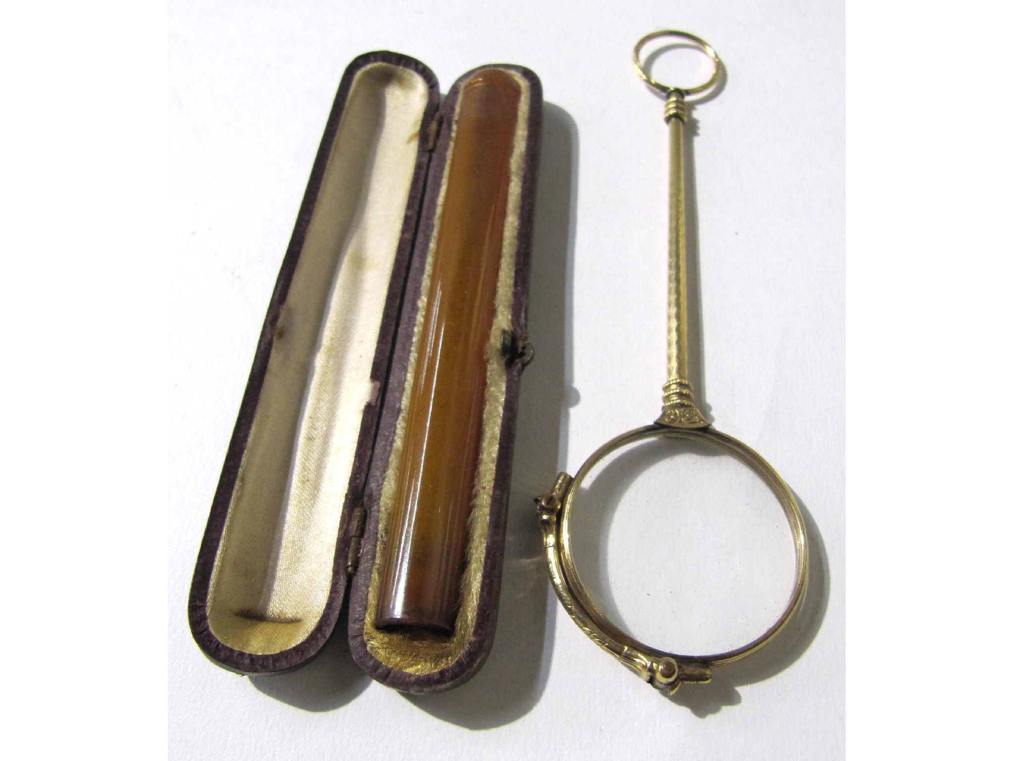 Appraisal: A lot comprising a lorgnette and an amber cigarette holder