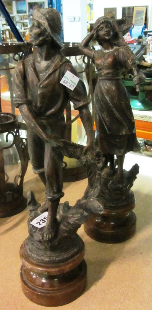 Appraisal: A pair of spelter figures on turned wooden bases