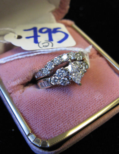 Appraisal: DIAMOND AND FOURTEEN KARAT WHITE GOLD WEDDING RING SET the