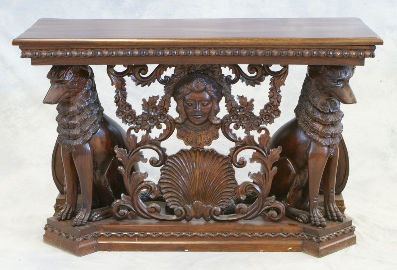 Appraisal: Carved mahogany console table with seated dogs flanking a shell