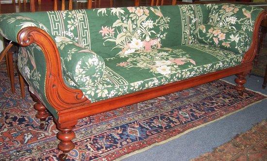 Appraisal: A Victorian walnut framed scroll end settee raised on turned