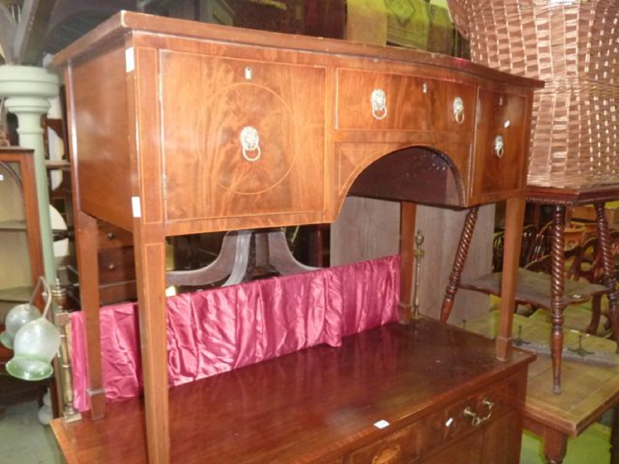 Appraisal: An Edwardian mahogany serpentine sideboard in the Georgian style the