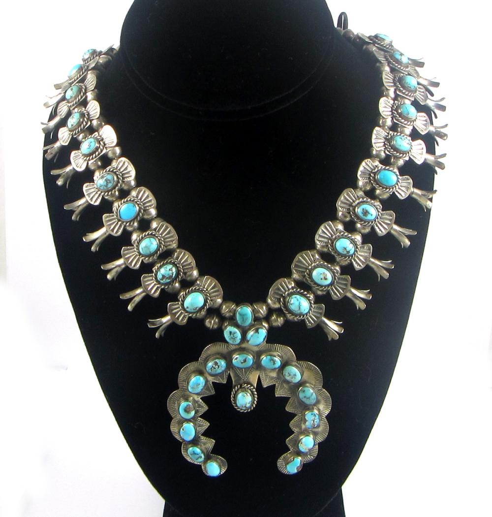 Appraisal: NATIVE AMERICAN SQUASH BLOSSOM NECKLACE featuring silver blossoms each bezel