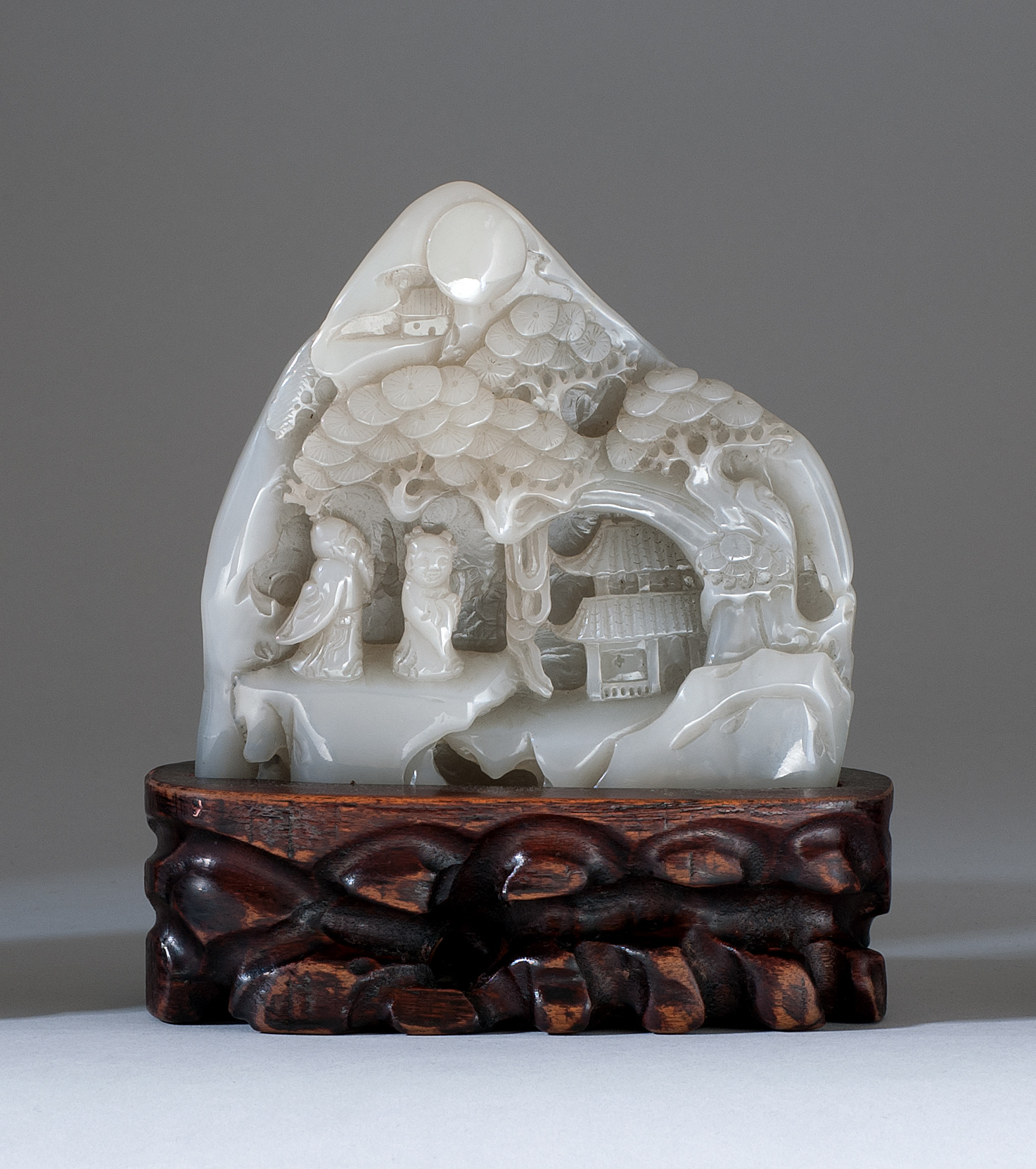 Appraisal: GRAY JADE MOUNTAIN With relief carving of a sage and