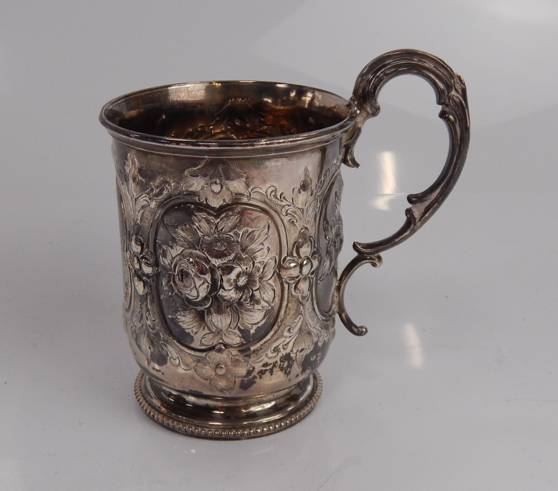 Appraisal: A Victorian silver christening mug with scroll handle and embossed