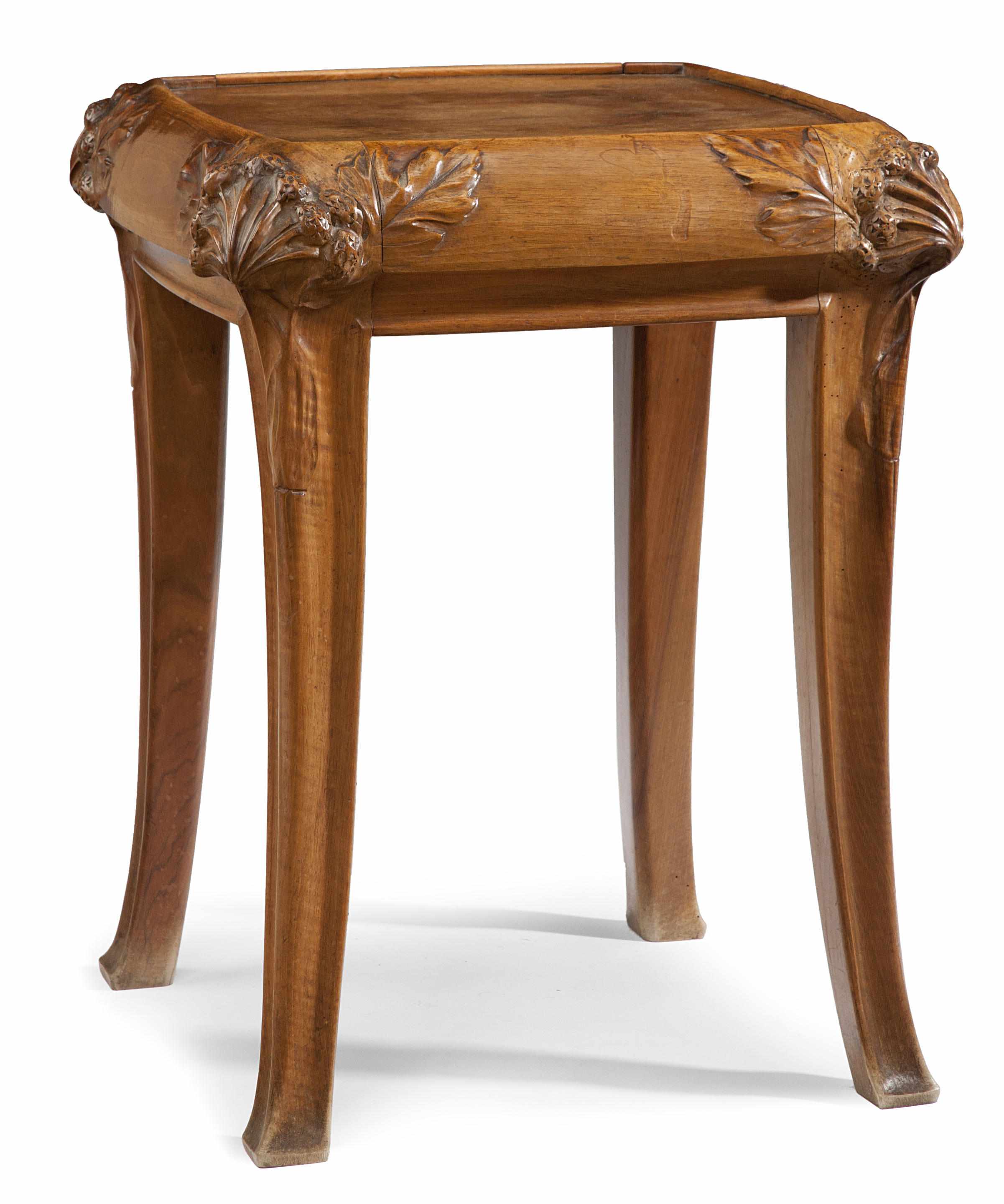 Appraisal: An Art Nouveau carved walnut occasional table attributed to Louis