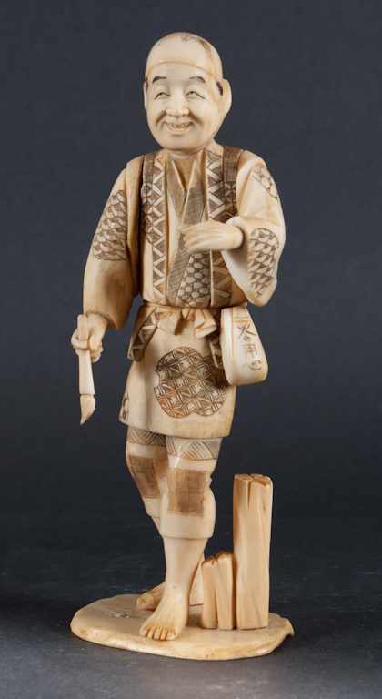 Appraisal: Japanese carved ivory figure of a man holding a brush