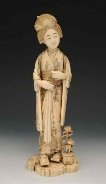 Appraisal: A JAPANESE CARVED IVORY MODEL of a Geisha in traditional